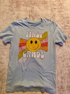 First Grade Smiley Graphic women’s Tee - Light Blue